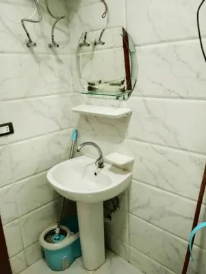 a white bathroom with a sink and a mirror at Tiba view in Hurghada