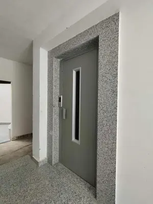 a gray door in a room with a wall at Tiba view in Hurghada