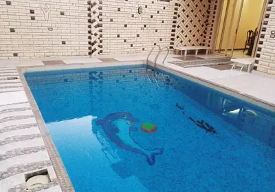a swimming pool with a snake in the water at THE Nile Diamond Guest House in Luxor