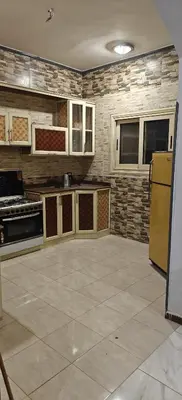 a large kitchen with a yellow refrigerator and cabinets at THE Nile Diamond Guest House in Luxor