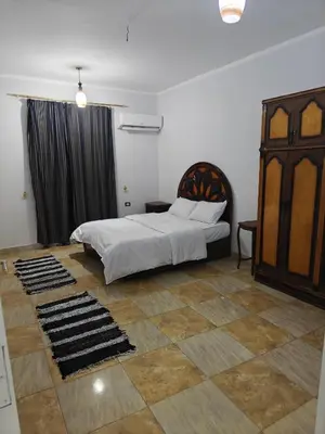 a bedroom with a bed in a room with a floor at THE Nile Diamond Guest House in Luxor