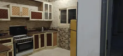 a kitchen with a stove and a refrigerator at THE Nile Diamond Guest House in Luxor