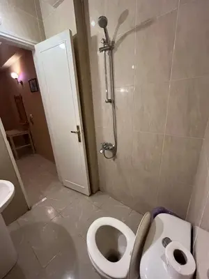 a small bathroom with a toilet and a shower at Rock star Hotel in Luxor