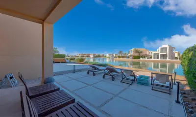 a patio with chairs and a view of the water at Luxury Stays in Tawila El Gouna in Hurghada