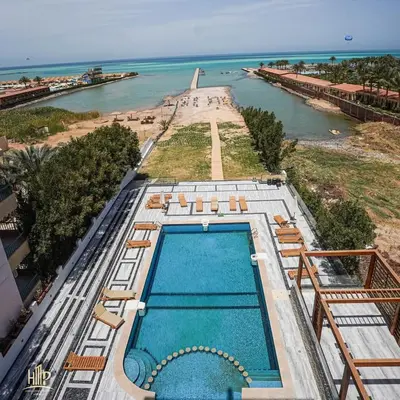 an overhead view of a swimming pool next to the ocean at Luxury apartment with beautiful view and free private beach in Hurghada