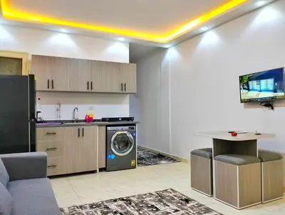 a kitchen with a washing machine in a room at Luxury apartment with beautiful view and free private beach in Hurghada