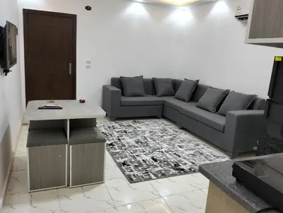a living room with a couch and a table at Luxury apartment with beautiful view and free private beach in Hurghada