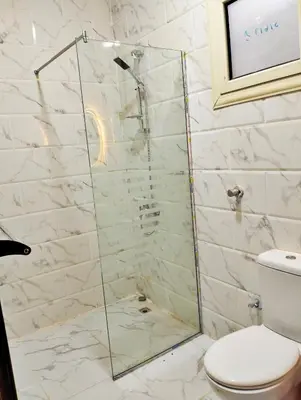 a shower with a glass door in a bathroom at Luxury apartment with beautiful view and free private beach in Hurghada
