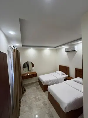 a hotel room with two beds and a mirror at شاليه بقرية ميراج باي in Hurghada