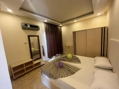 a bedroom with a bed with a tennis ball on it at شاليه بقرية ميراج باي in Hurghada