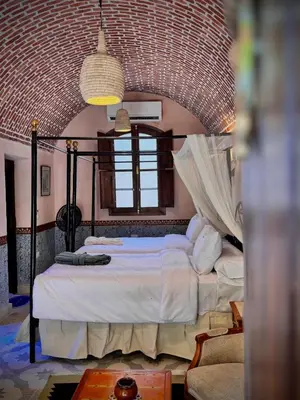 a bedroom with a large bed in a room at El Juneina Villas in Luxor