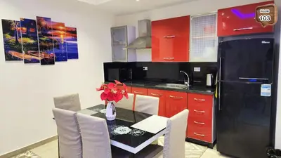 a kitchen with a table and a black refrigerator at Touristic centre beach1 in Hurghada