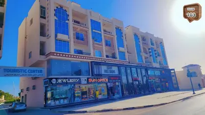 a large building on a street with a store at Touristic centre beach1 in Hurghada