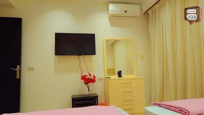 a bedroom with a flat screen tv on the wall at Touristic centre beach1 in Hurghada