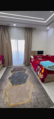 a bedroom with a bed and a rug on the floor at ميراج باى الغردقه in Hurghada