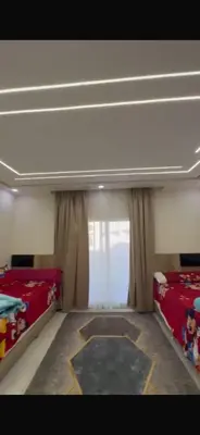 a bedroom with two beds and a window at ميراج باى الغردقه in Hurghada