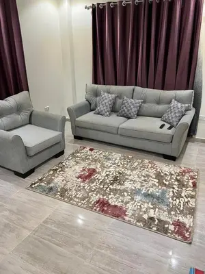 a living room with a couch and a rug at Royal view suite in Hurghada
