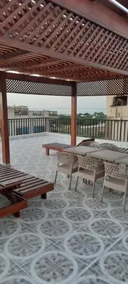 a patio with tables and chairs under a pavilion at Royal view suite in Hurghada