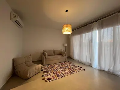 a living room with a couch and a large window at Cozy 1BR Retreat in Gouna in Hurghada