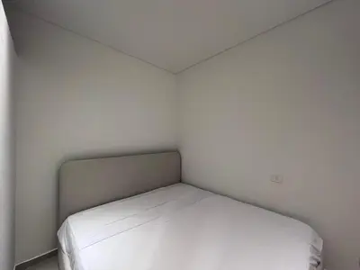 a small bedroom with a bed in the corner at Cozy 1BR Retreat in Gouna in Hurghada