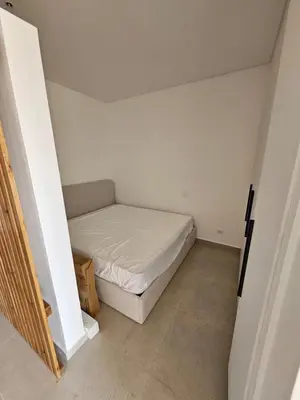 a small bedroom with a bed in a room at Cozy 1BR Retreat in Gouna in Hurghada