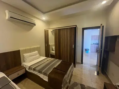 a bedroom with a bed and a door to a bathroom at شاليه ميراج باي ريزورت in Hurghada