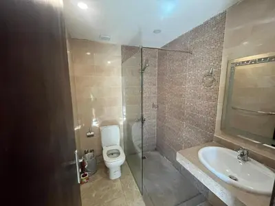 a bathroom with a toilet and a sink and a shower at شاليه ميراج باي ريزورت in Hurghada