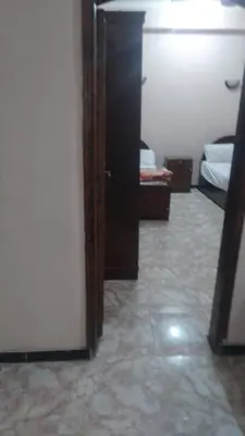 a room with a door and a room with two beds at The Nile apartment in Luxor