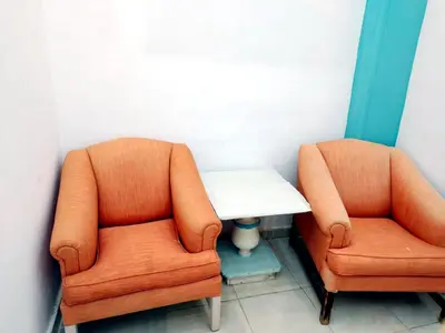 two orange chairs and a table in a room at room 3 a room in Hostel of 4 rooms in Hurghada