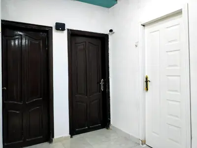 two black doors in a room with white walls at room 3 a room in Hostel of 4 rooms in Hurghada
