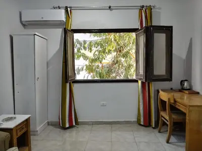 a room with a window with a desk and a table at room 3 a room in Hostel of 4 rooms in Hurghada