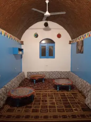 a living room with a couch and two tables at Kody doll in Jazīrat Suhayl