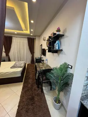 a room with a dining table and a bedroom at كمباوند فلورينزا خمسين وسط الغردقه in Hurghada