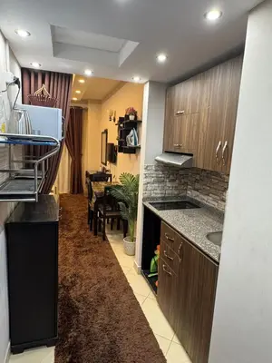 a kitchen with a counter and a dining room at كمباوند فلورينزا خمسين وسط الغردقه in Hurghada