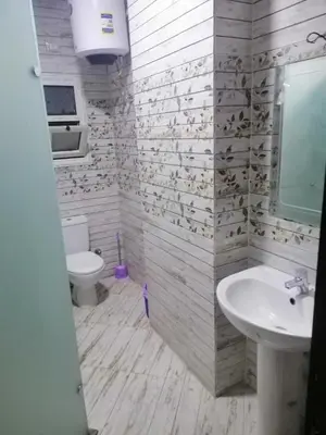 a white bathroom with a sink and a toilet at كذابلانكا بيتش in Hurghada