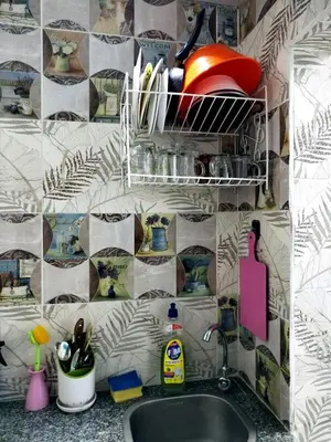 a kitchen with a sink and a tiled wall at room2 a room in Hostel of 4 rooms in Hurghada
