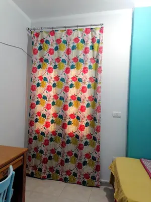 a shower curtain with a floral pattern in a room at room2 a room in Hostel of 4 rooms in Hurghada