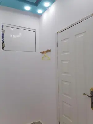 a white wall with a door in a room at room1 a room in Hostel of 4 rooms in Hurghada