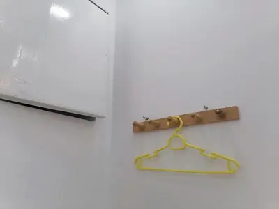 a towel rack on a wall next to a window at room1 a room in Hostel of 4 rooms in Hurghada