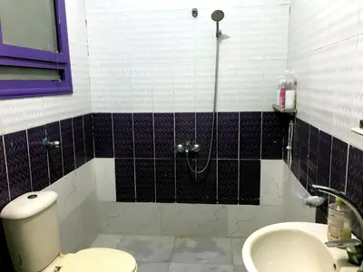 a bathroom with a shower and a toilet and a sink at room1 a room in Hostel of 4 rooms in Hurghada