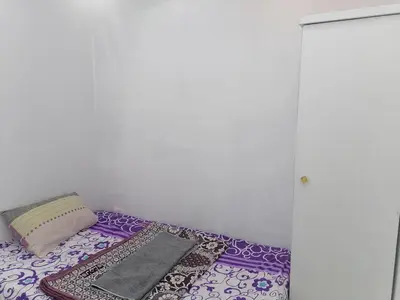 a purple couch with a pillow and a blanket at room1 a room in Hostel of 4 rooms in Hurghada