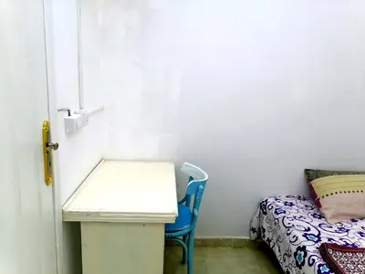 a small room with a desk and a bed at room1 a room in Hostel of 4 rooms in Hurghada