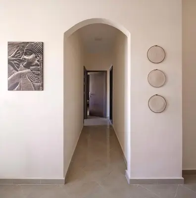 a hallway with an archway and a painting on the wall at Bayt Hassan A3 - 2 bedrooms European style Apartment in Hurghada