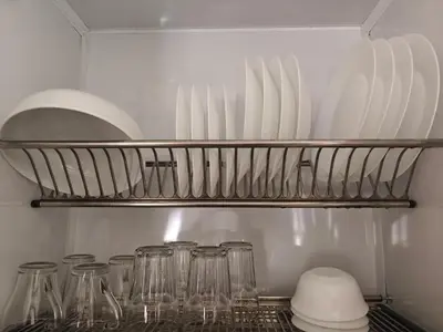 a kitchen with glasses on a shelf in a refrigerator at Bayt Hassan A11 - 2 bedrooms spacious appartment in Hurghada