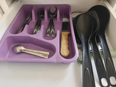 a purple tray filled with utensils on a shelf at Bayt Hassan A11 - 2 bedrooms spacious appartment in Hurghada