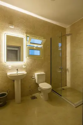 a bathroom with a toilet and a sink and a shower at Bayt Hassan A11 - 2 bedrooms spacious appartment in Hurghada