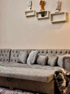 a couch in a living room with shelves on the wall at studio in El Gouna-mangroovy , Egypt in Hurghada