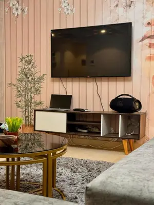 a living room with a large television on a wall at studio in El Gouna-mangroovy , Egypt in Hurghada
