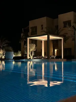 a swimming pool at night with a gazebo at studio in El Gouna-mangroovy , Egypt in Hurghada