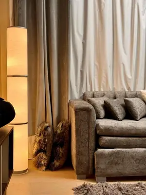 a living room with a couch in front of a curtain at studio in El Gouna-mangroovy , Egypt in Hurghada